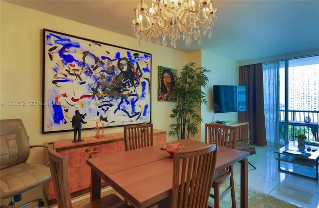 a view of a dining room with furniture a livingroom and chandelier