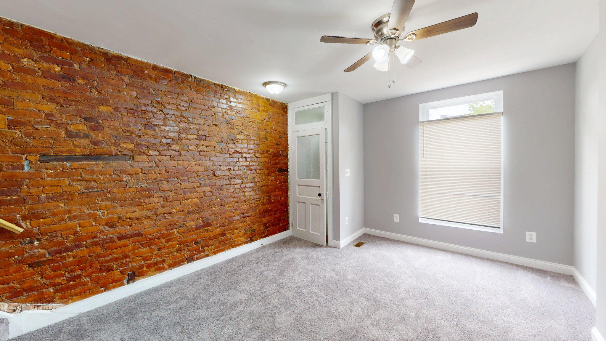 1826 Ramsay Street Baltimore, MD 21223 - Photo 3 of 16 Living Room with Exposed Brick