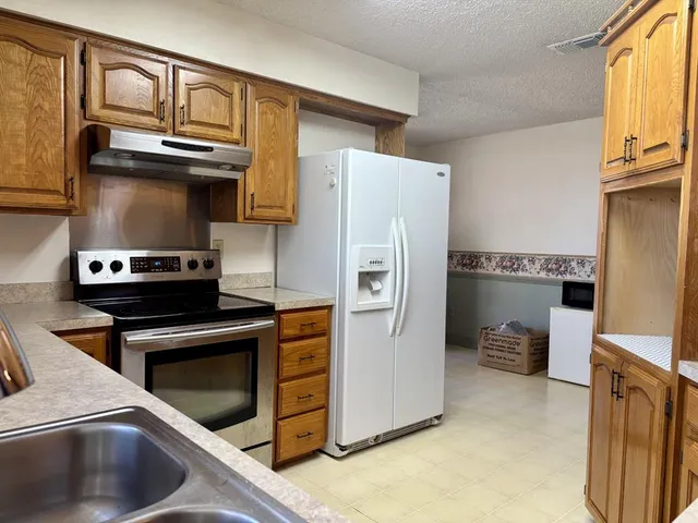 a room with a bed and wooden floor