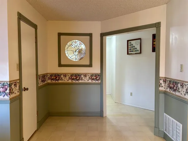 a view of a livingroom with wooden floor and a flat screen tv