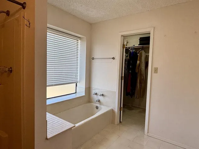 a view of a backyard with lawn chairs