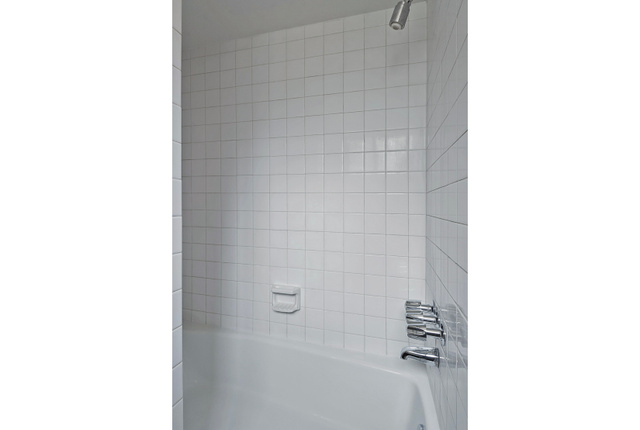 1722 Kimsbrough Road Sandy, UT 84092 - Photo 23 of 29 Bathtub with white subway tile surround, chrome shower head, and coordinating faucet with separate controls