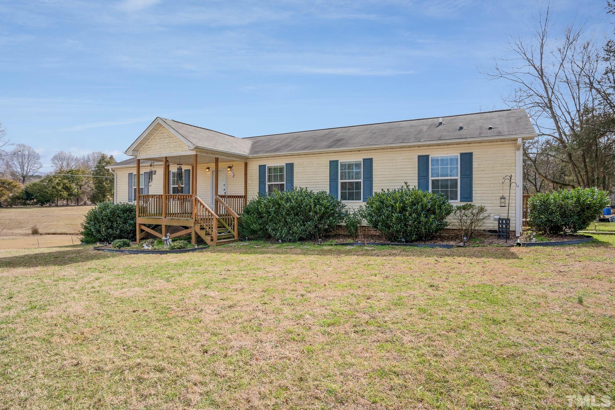 410 Bahama Road Bahama, NC 27503 - Photo 3 of 21 a front view of house with yard and trees around