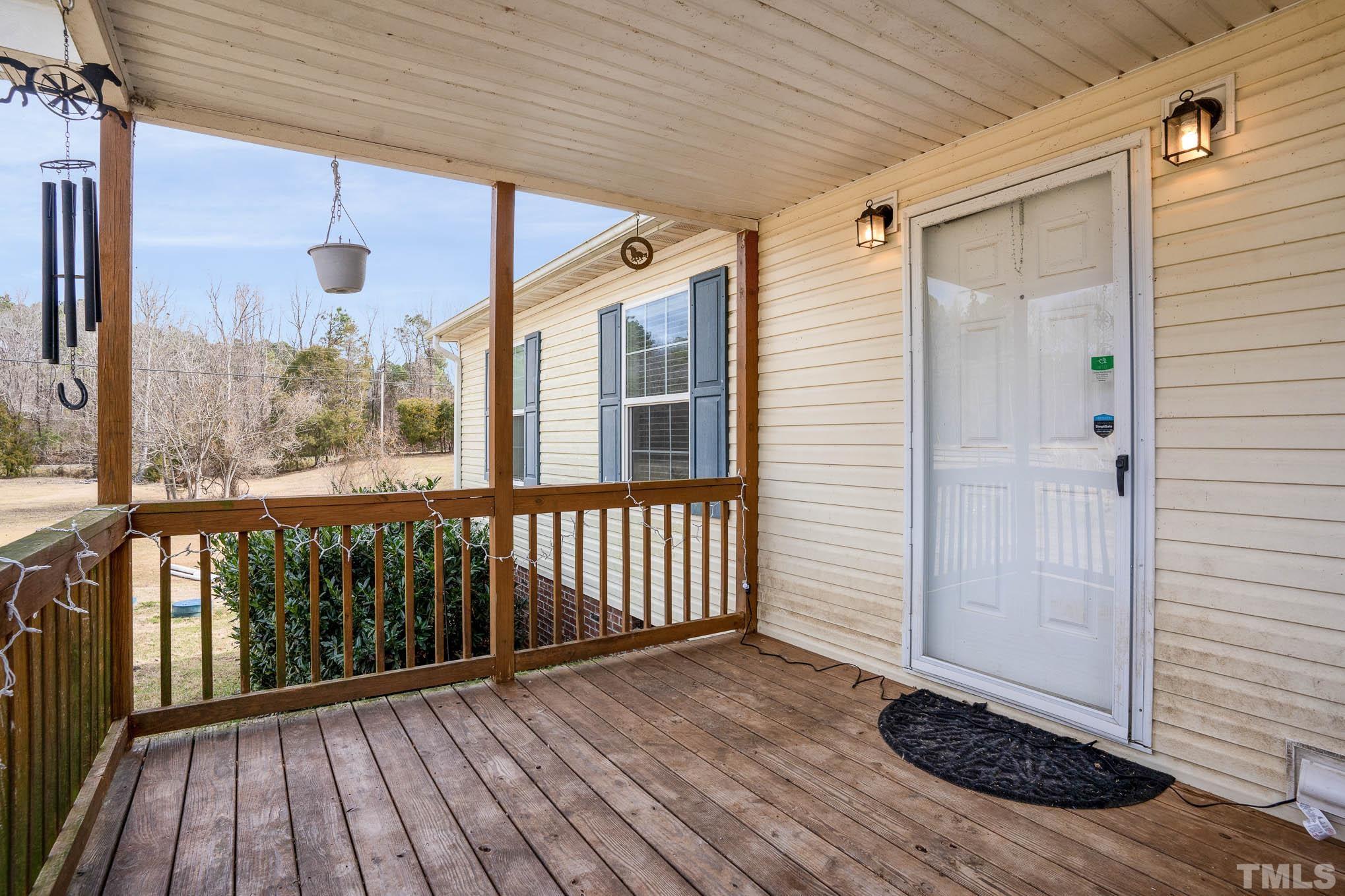 410 Bahama Road Bahama, NC 27503 - Photo 5 of 21 a view of a porch with wooden floor
