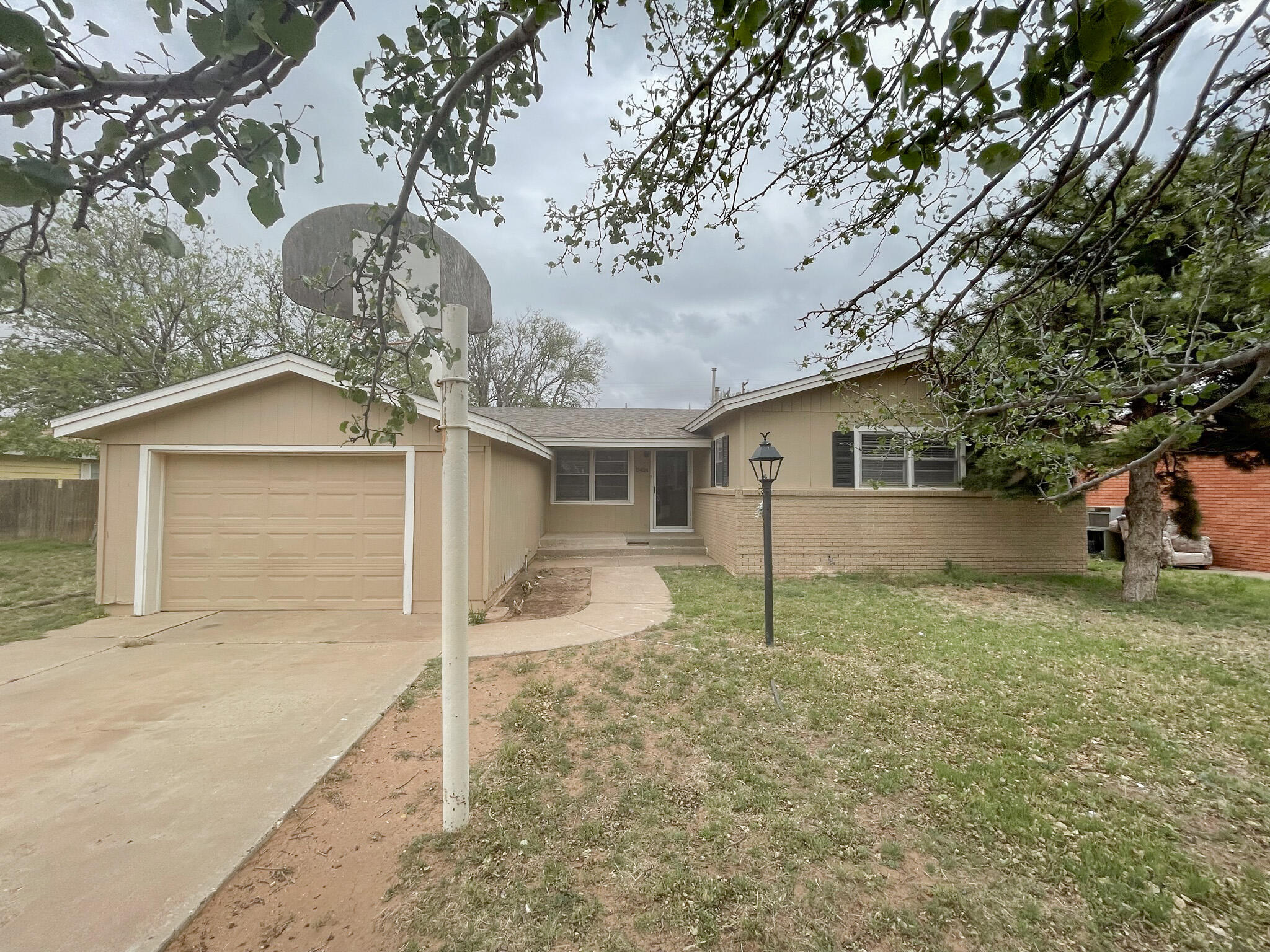 5424 23rd Street Lubbock, TX 79407 - Photo 1 of 11 a house with a large tree in front of it