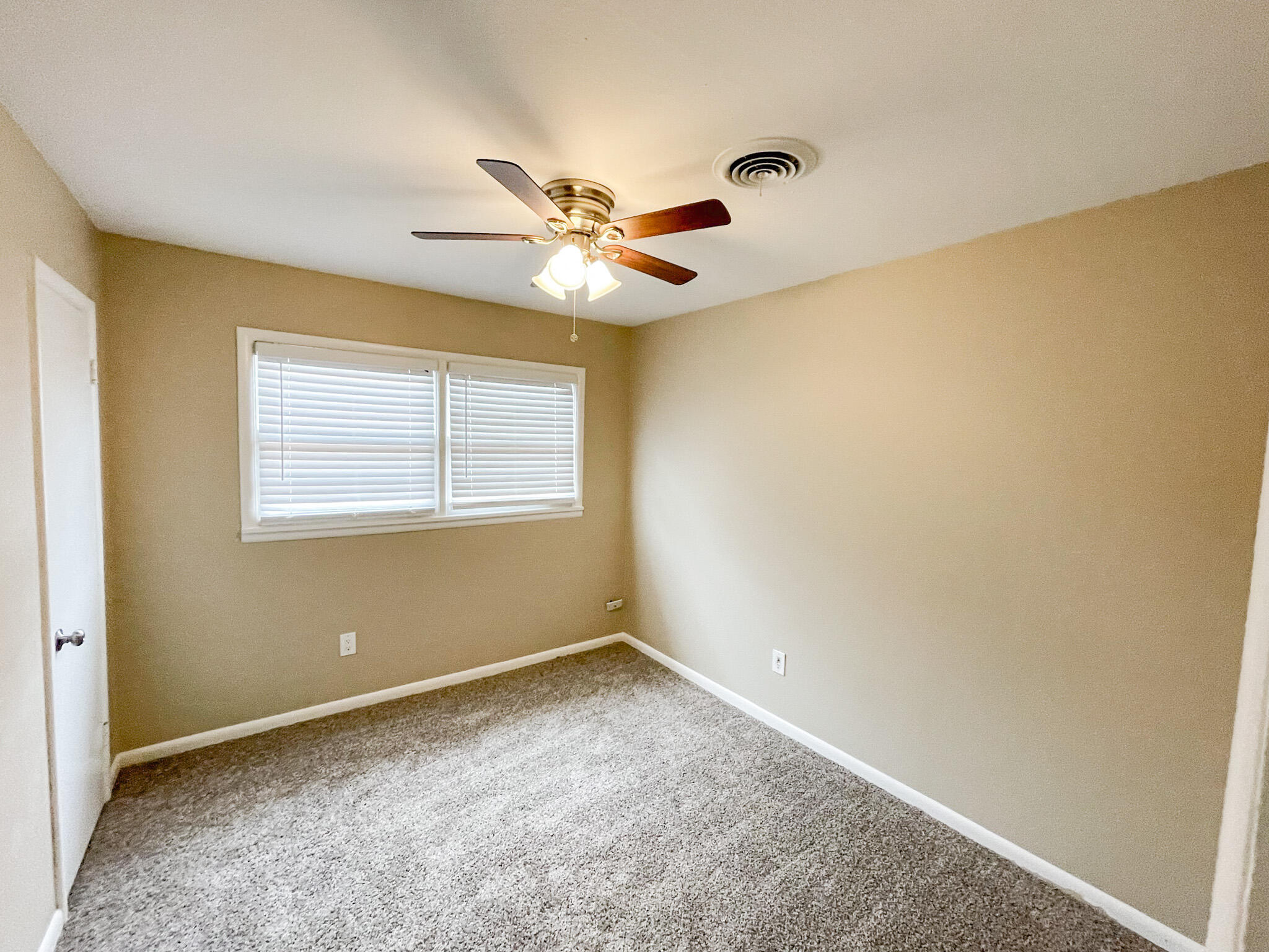 5424 23rd Street Lubbock, TX 79407 - Photo 7 of 11 a view of an empty room with chandelier fan and a window