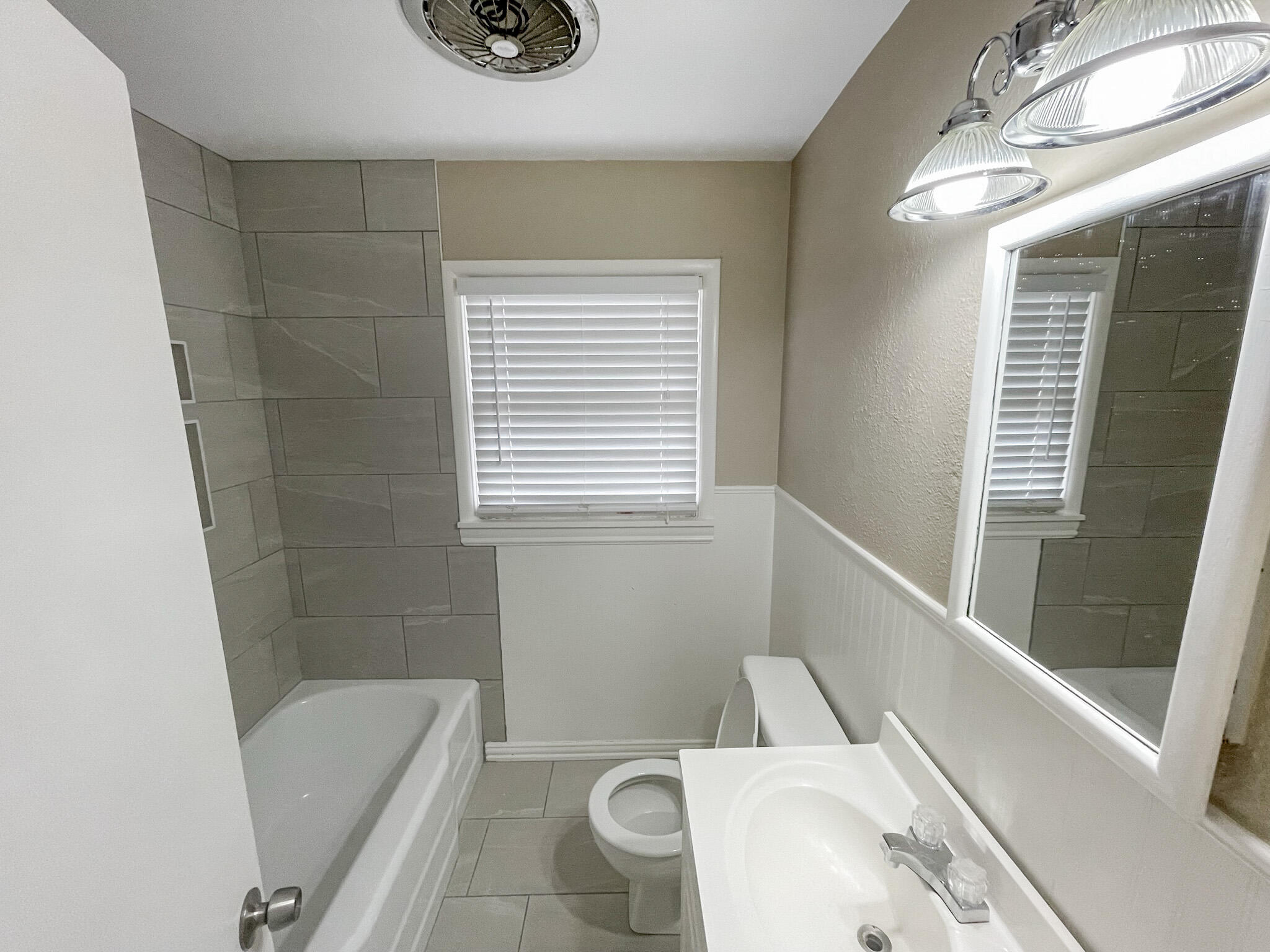 5424 23rd Street Lubbock, TX 79407 - Photo 8 of 11 a bathroom with a sink a bathtub and window