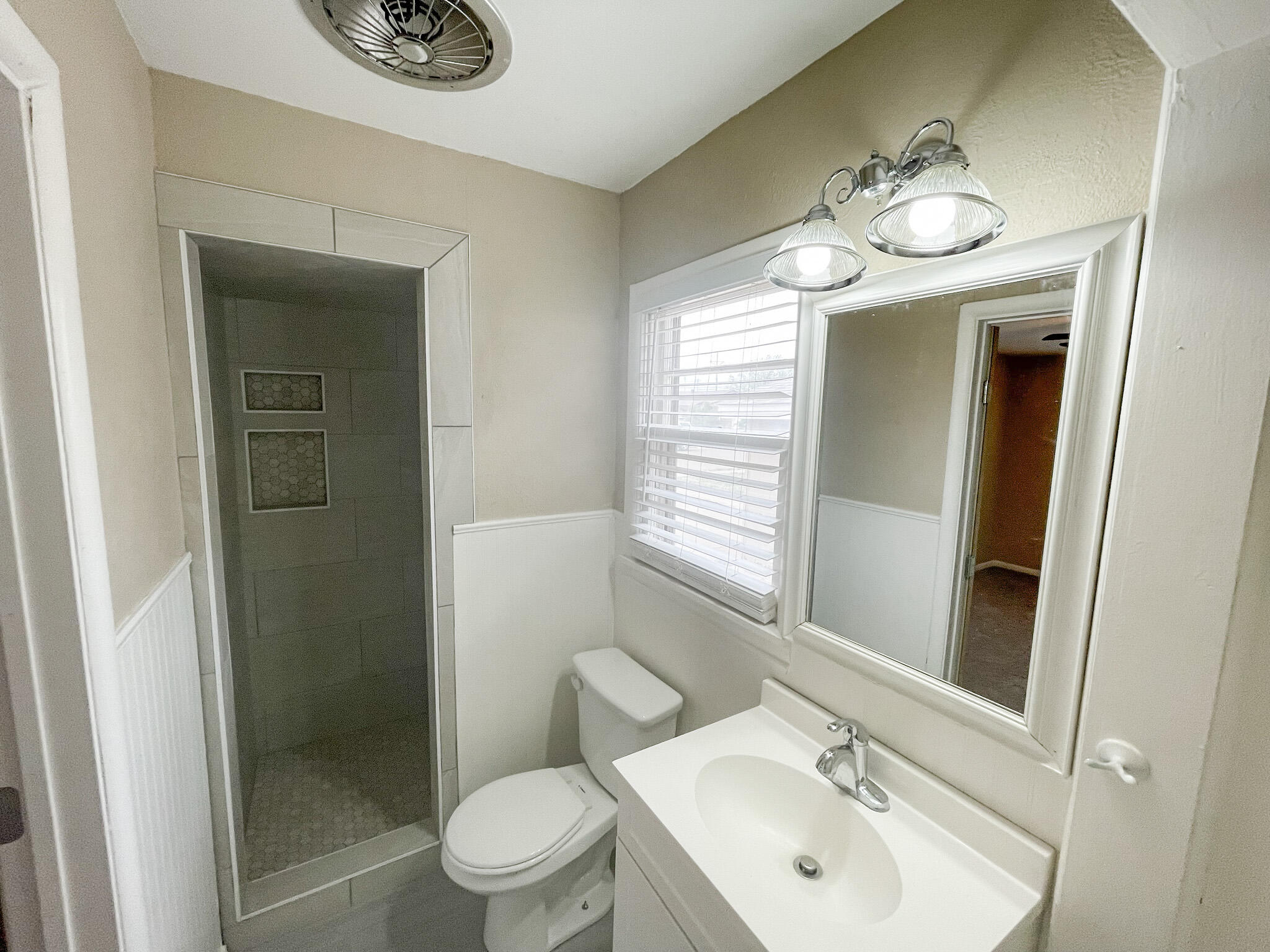 5424 23rd Street Lubbock, TX 79407 - Photo 10 of 11 a bathroom with a toilet sink and mirror