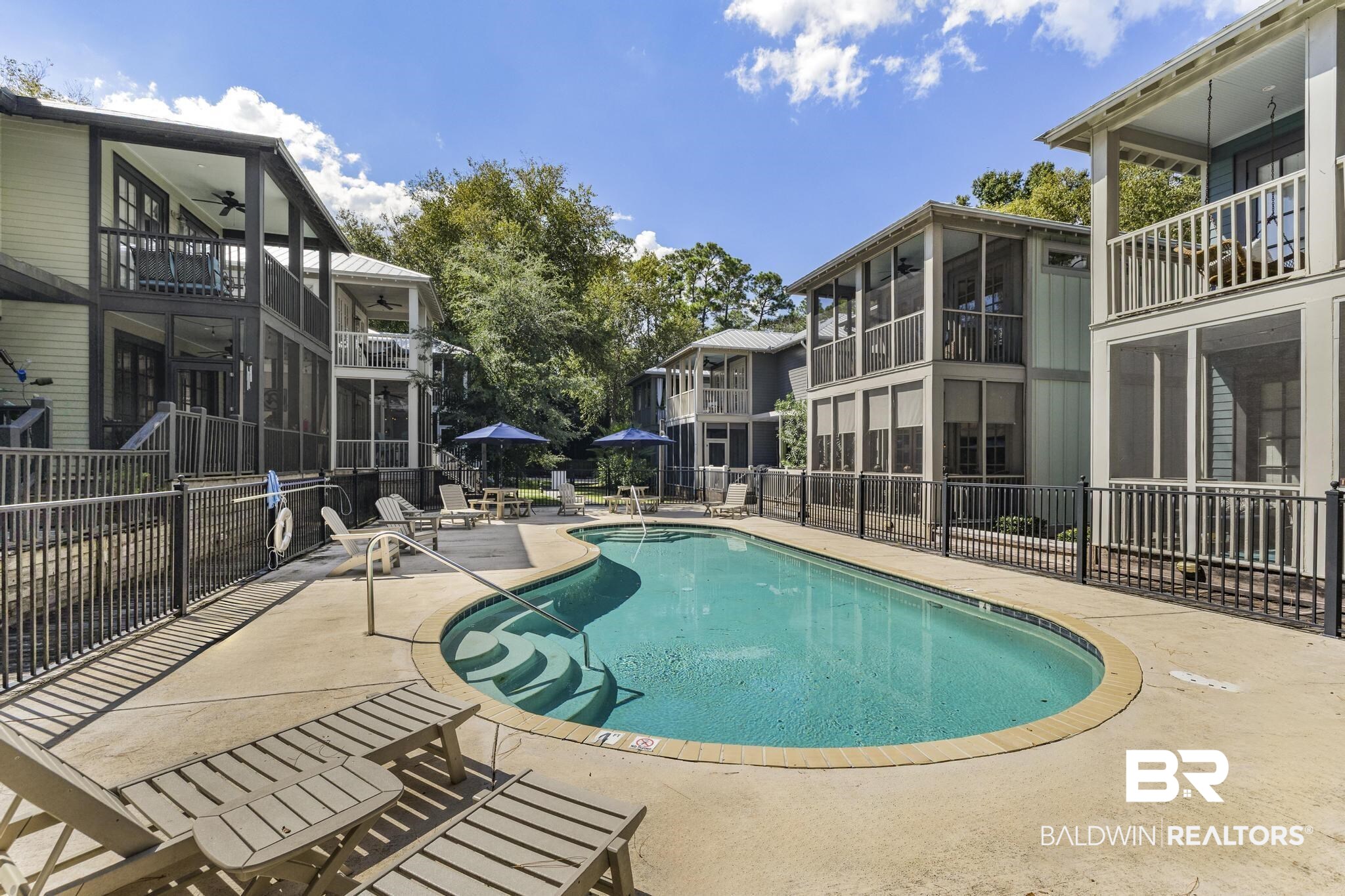 25773 Canal Road Orange Beach, AL 36561 - Photo 8 of 32 Community pool featuring a patio area, a balcony, and a sunroom