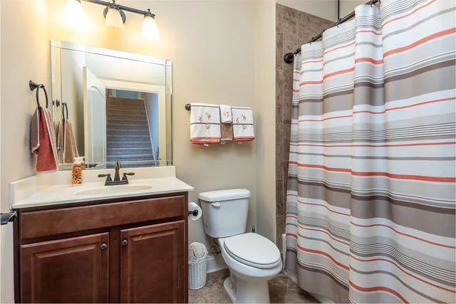 a bathroom with a sink toilet and mirror