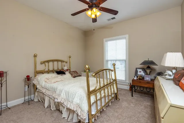 a bedroom with bed and a chandelier