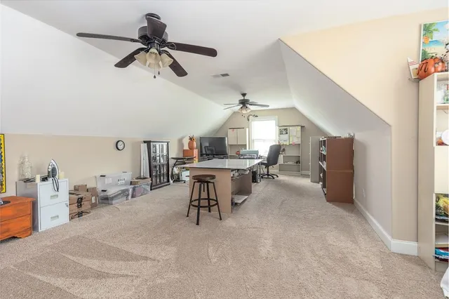 a view of a livingroom with workspace and a window