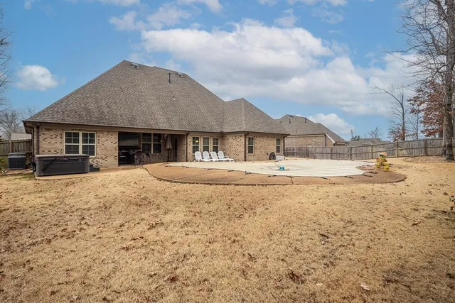 a front view of a house with swimming pool and furniture