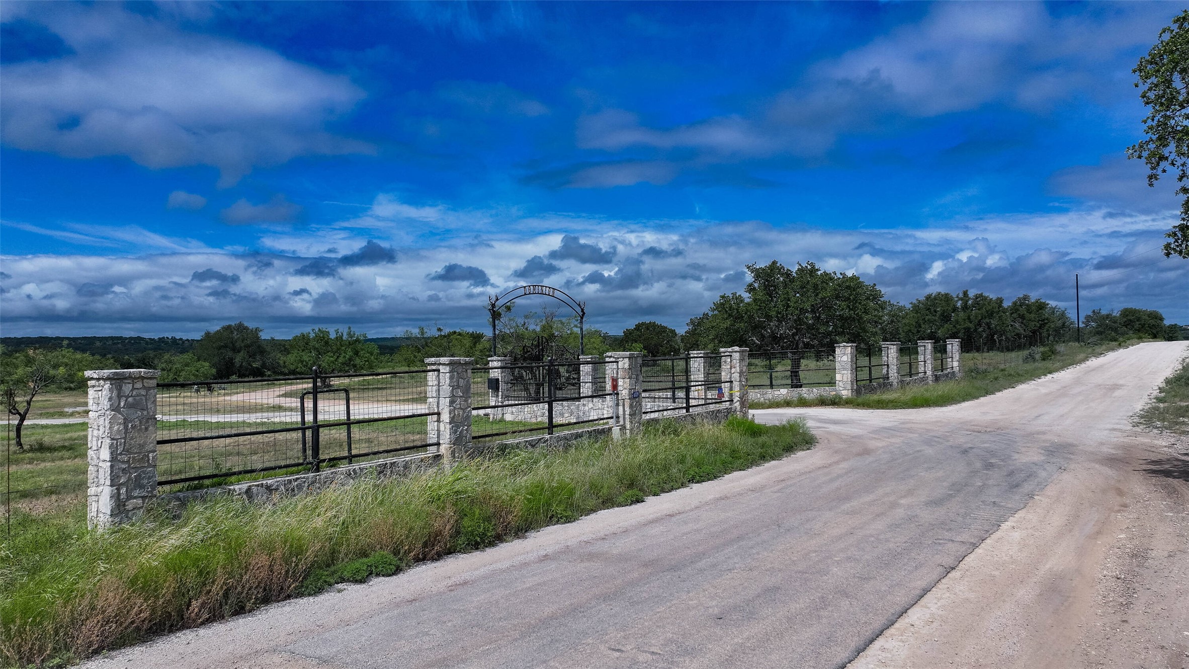 5 Dominion At Oak Ridge Junction, TX 76849 - Photo 18 of 34 Stone column entrance with wrought iron fencing and gates