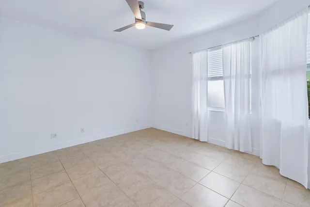 an empty room with a empty space and windows