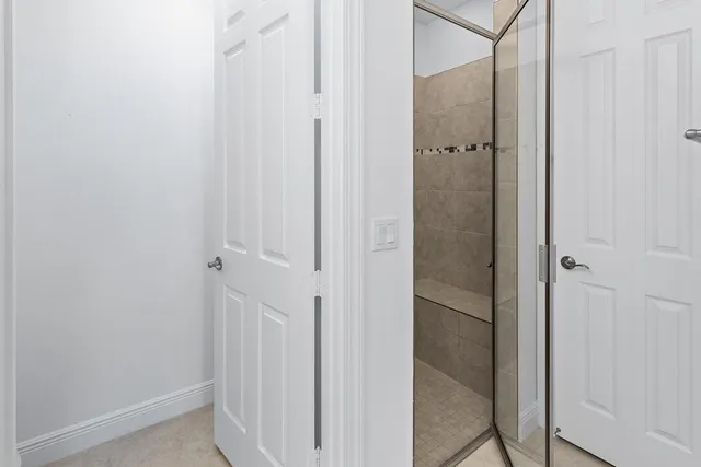 a spacious bedroom with a bed and a window