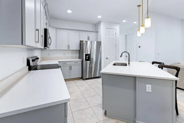 a kitchen with a sink stainless steel appliances and cabinets