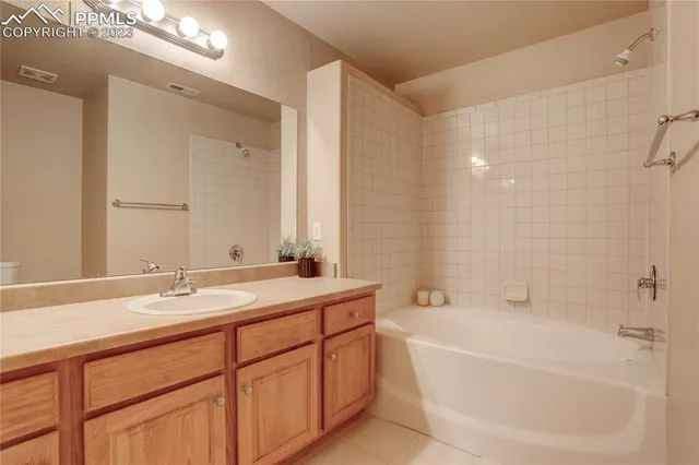 a bathroom with a tub sink and mirror