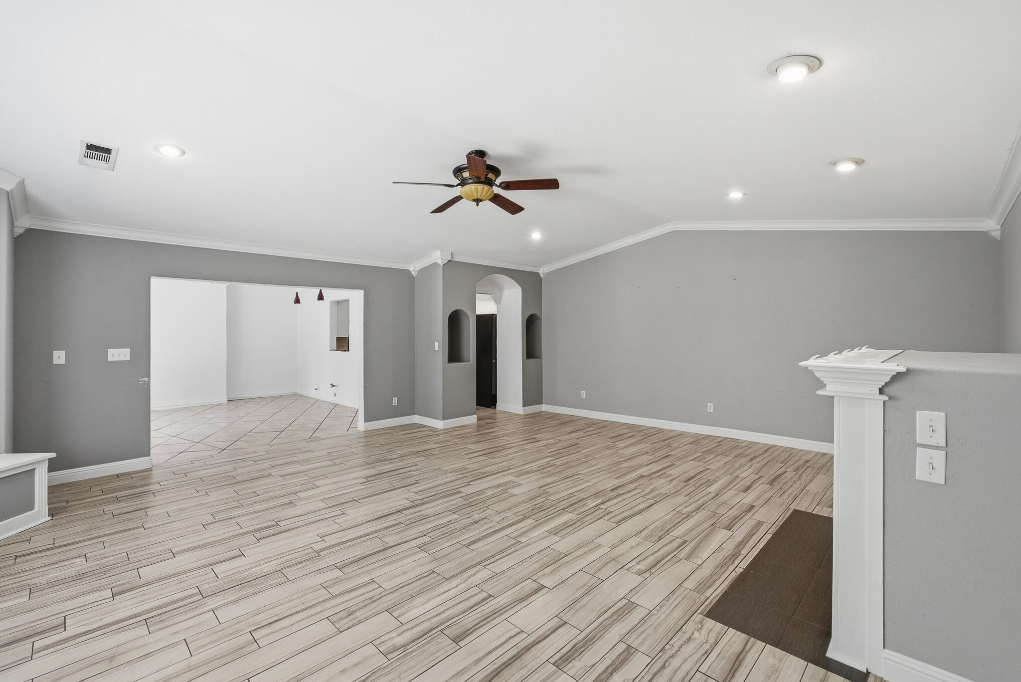 618 Birdsong Court Exeter, CA 93221 - Photo 17 of 62 a view of an empty room with a chandelier fan and wooden floor