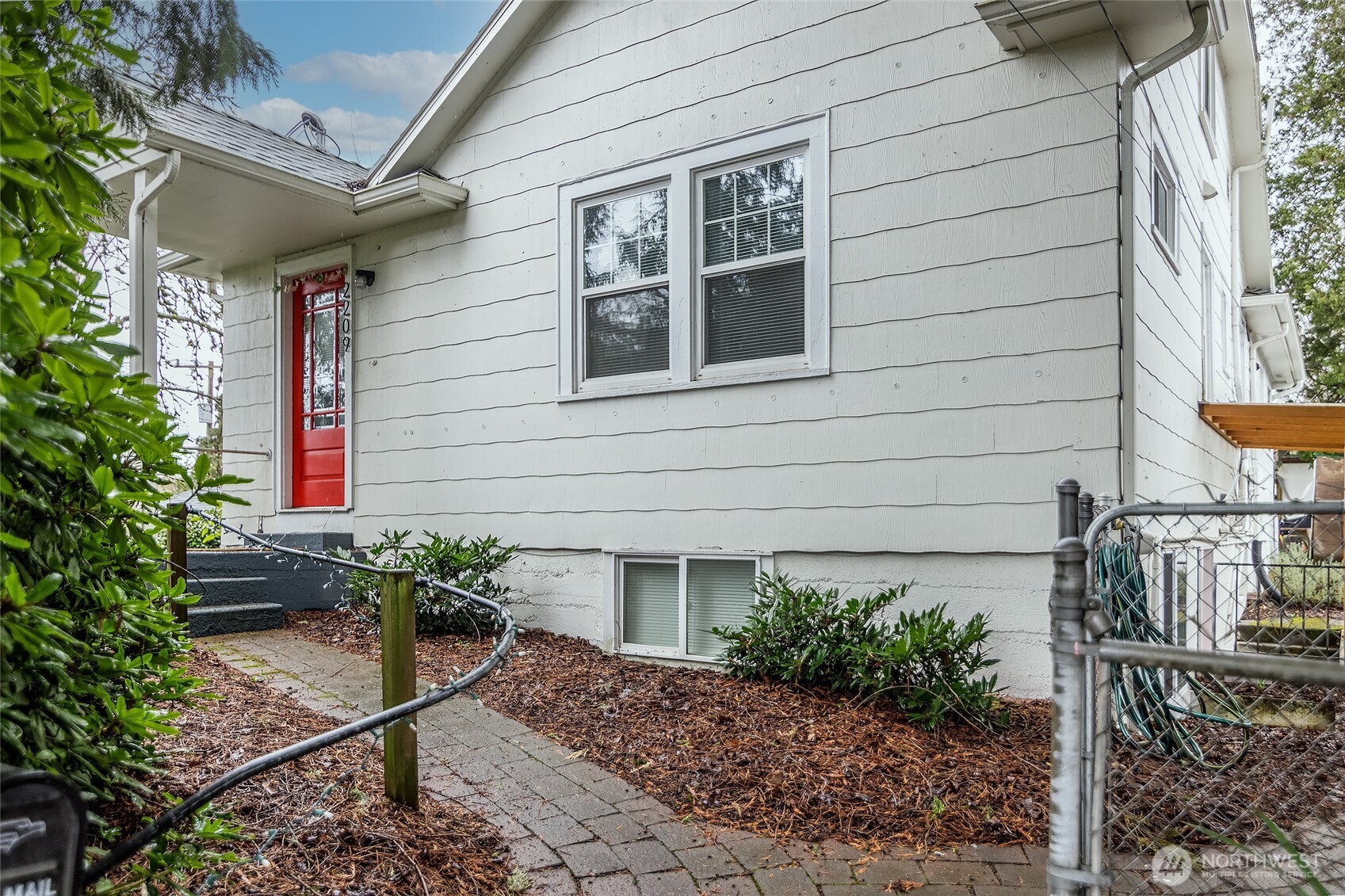 2209 East Roanoke Street Seattle, WA 98112 - Photo 2 of 31 a house with a flower garden