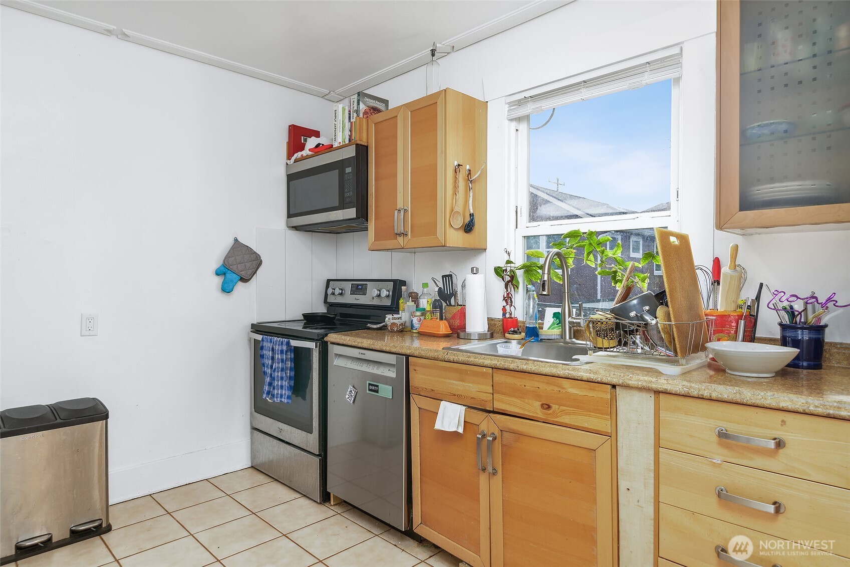 2209 East Roanoke Street Seattle, WA 98112 - Photo 10 of 31 a kitchen with stainless steel appliances granite countertop a sink stove and cabinets