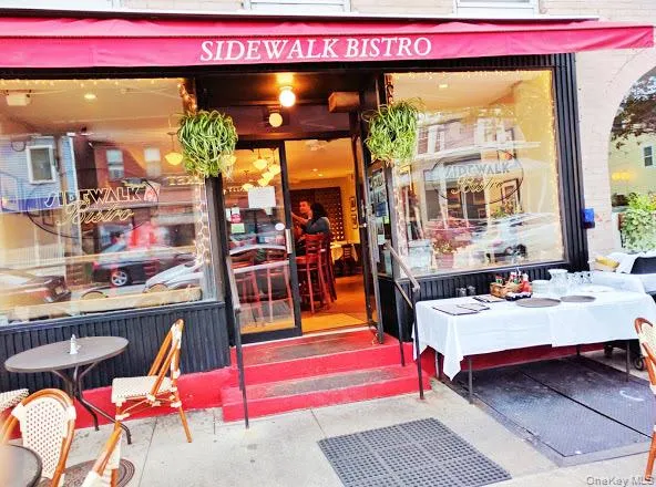 a view of a chairs and table in the patio and a backyard
