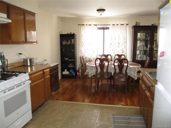 a kitchen with a table chairs refrigerator and cabinets