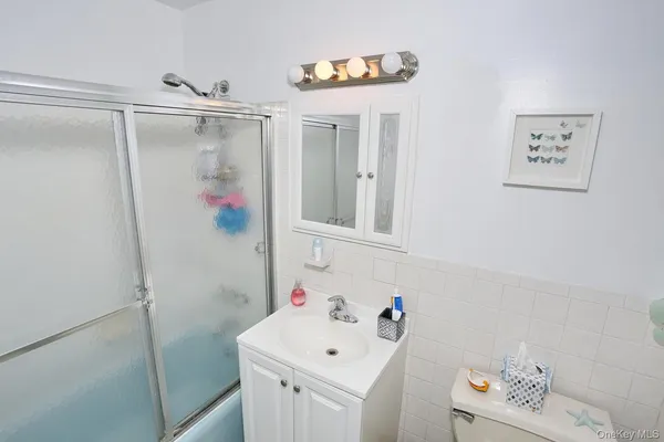 a bathroom with a sink vanity and mirror