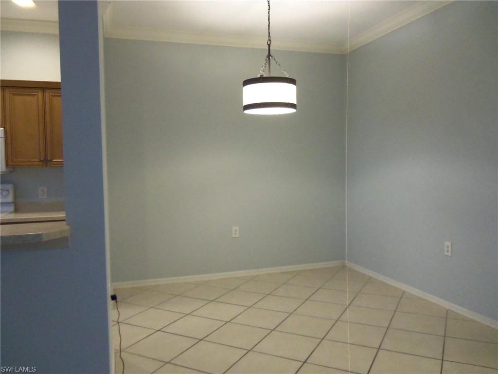 8490 Kingbird Loop, Unit 947 Estero, FL 33967 - Photo 11 of 16 a view of a room with a hanging light and kitchen