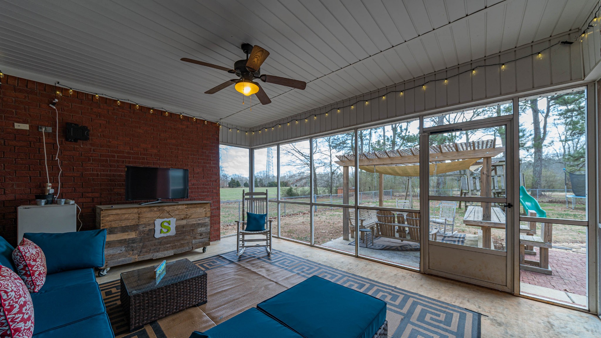 262 West Limestone Road Hazel Green, AL 35750 - Photo 31 of 45 a living room with furniture a flat screen tv and a floor to ceiling window