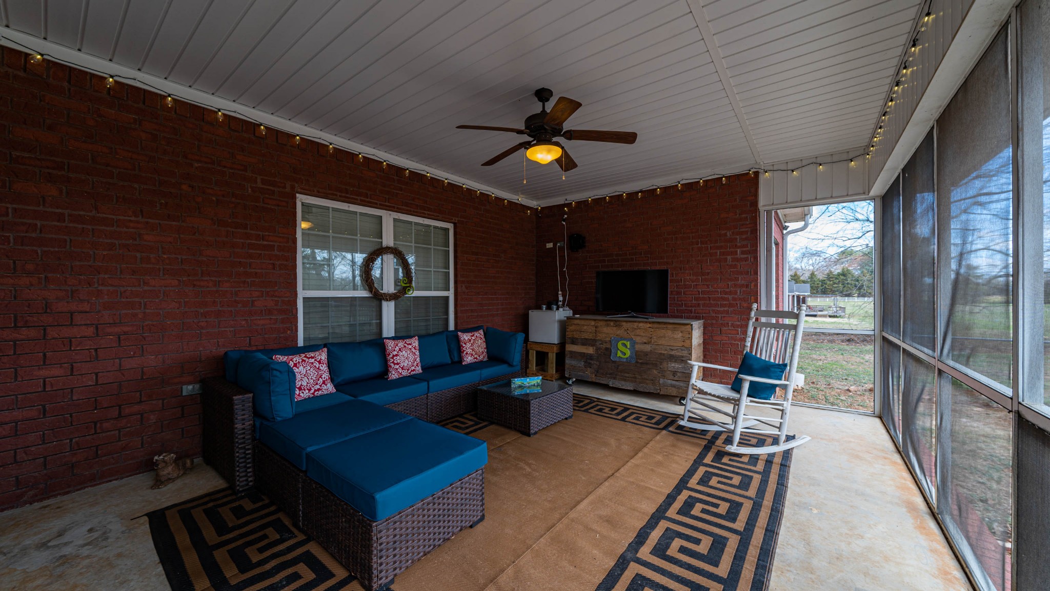 262 West Limestone Road Hazel Green, AL 35750 - Photo 32 of 45 a living room with furniture a flat screen tv and a fireplace