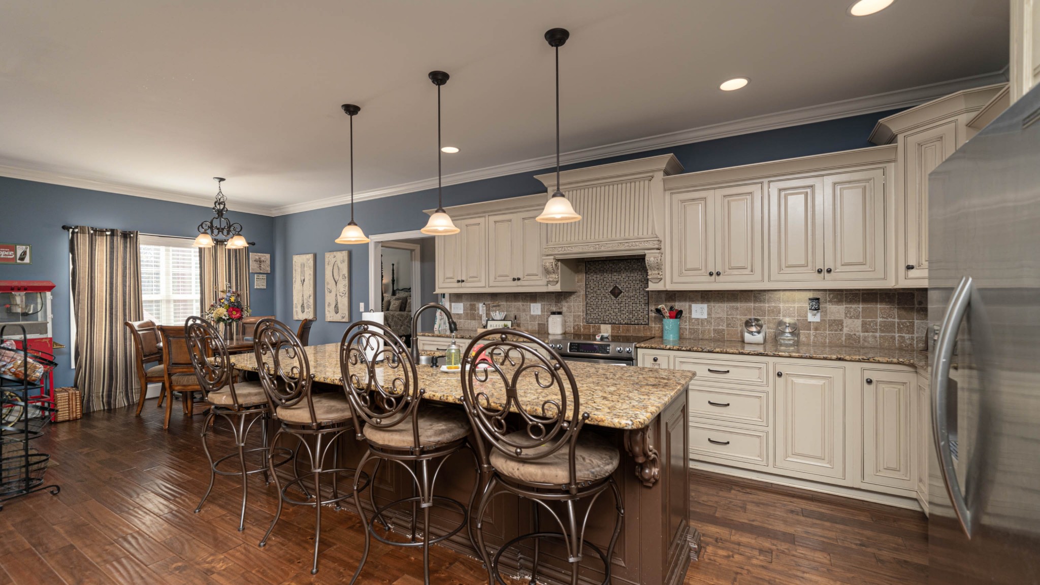 262 West Limestone Road Hazel Green, AL 35750 - Photo 8 of 45 a open kitchen with stainless steel appliances granite countertop a stove top oven a sink a dining table and chairs with wooden floor