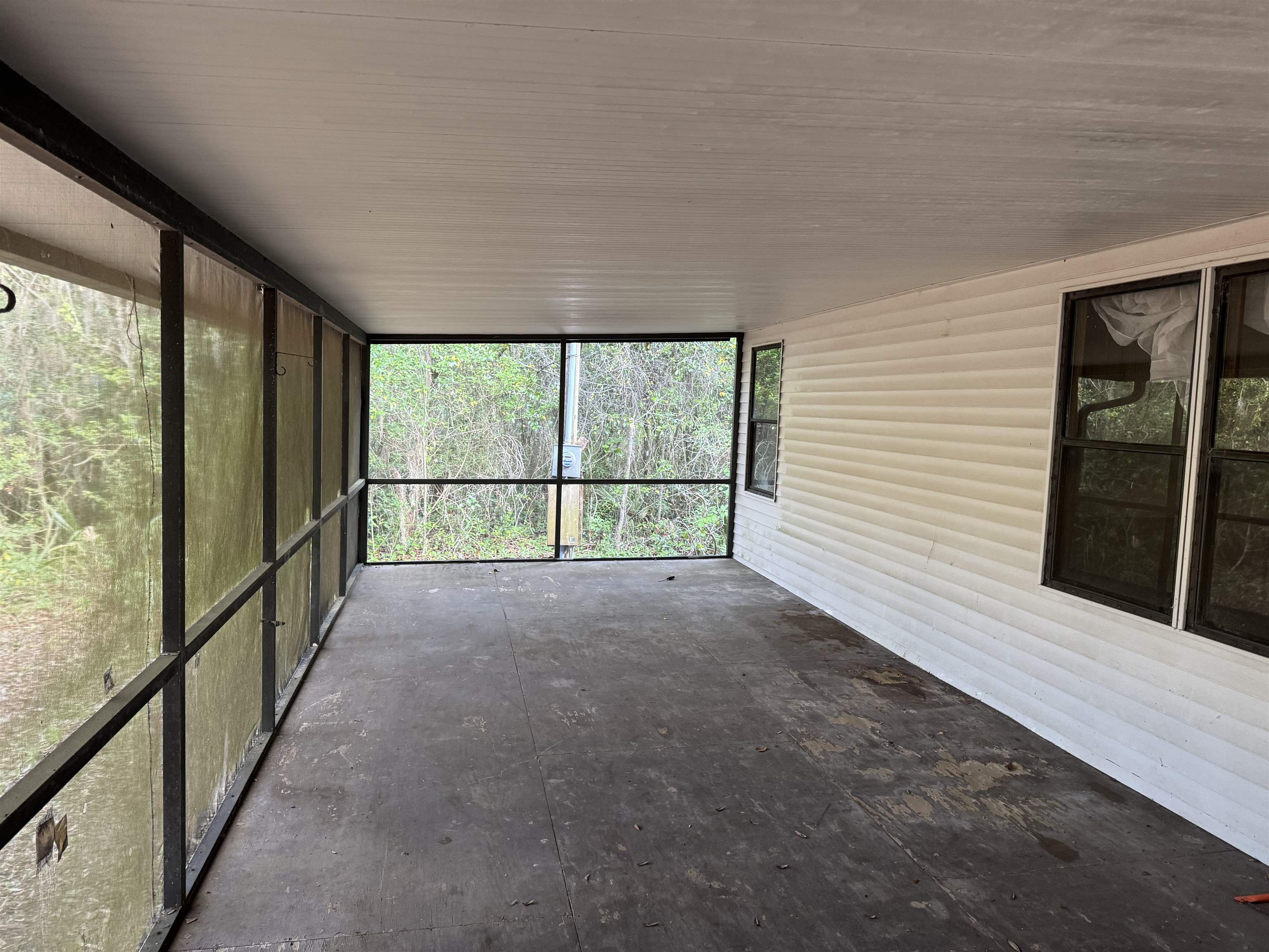 608 Coral Farms Road Florahome, FL 32140 - Photo 6 of 20 a view of a room with wooden floor and windows
