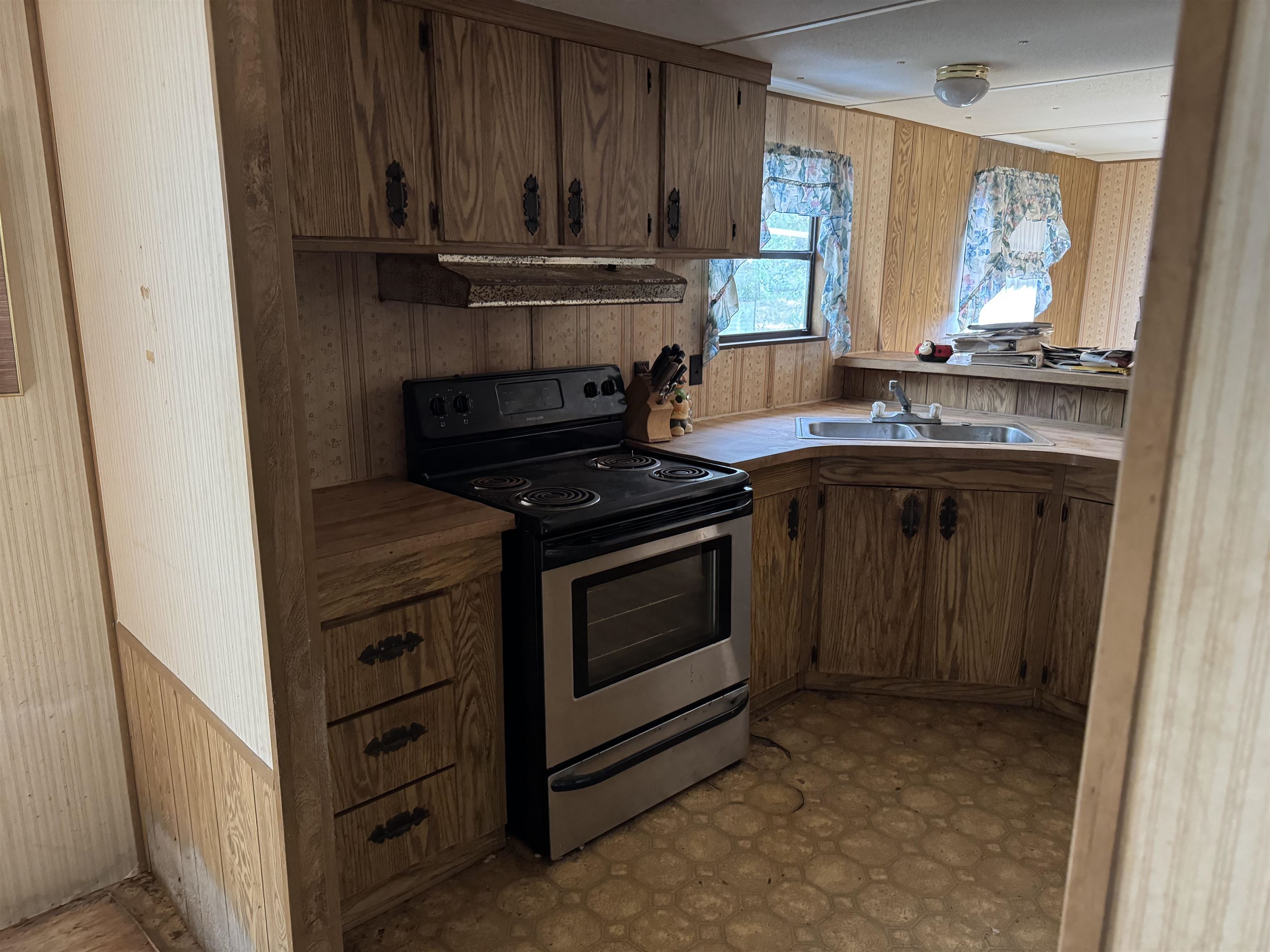 608 Coral Farms Road Florahome, FL 32140 - Photo 8 of 20 a kitchen with granite countertop a stove sink and cabinets