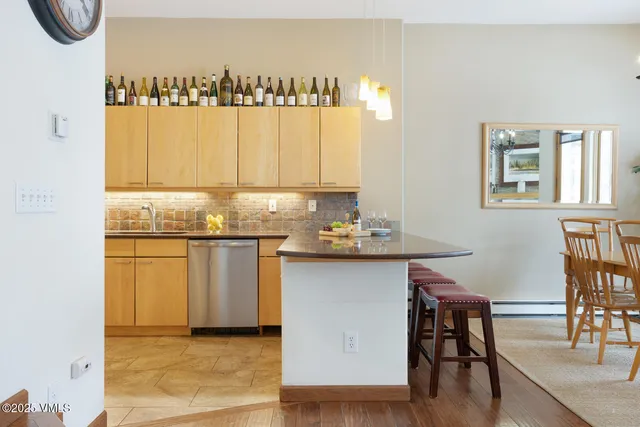 a kitchen with a table chairs and a stove