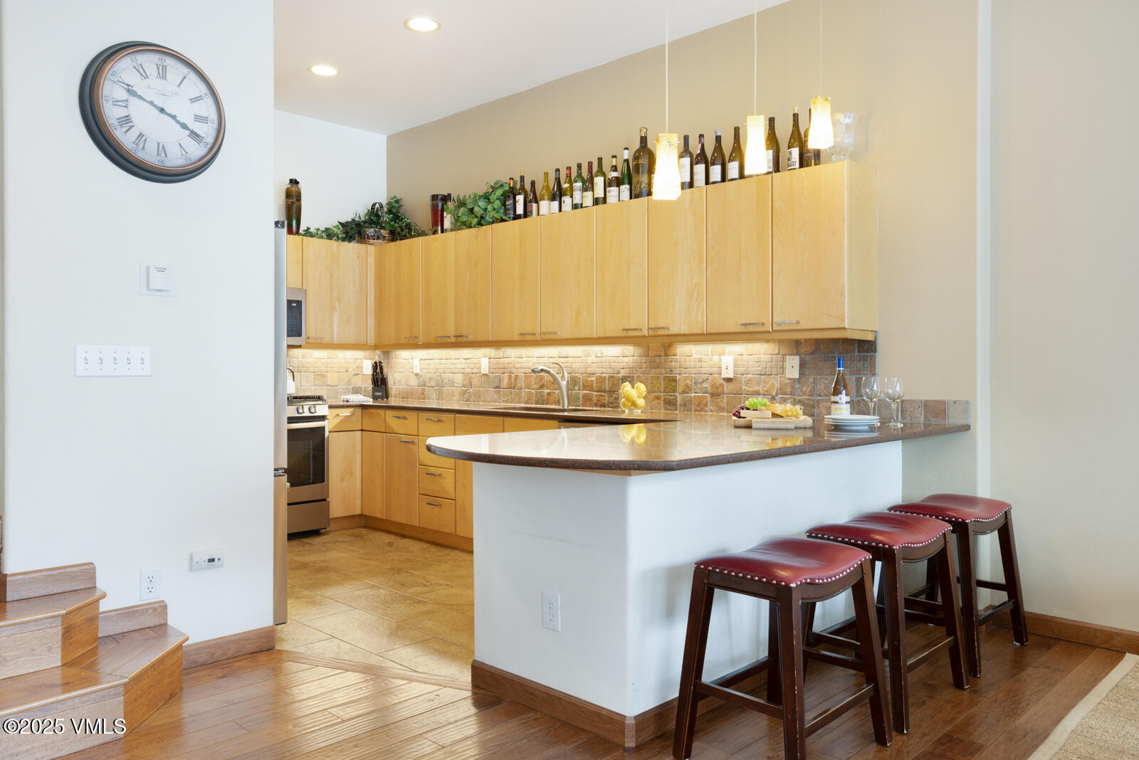 1230 Lions Ridge Loop, Unit 2D Vail, CO 81657 - Photo 16 of 42 a kitchen with a table chairs and a stove