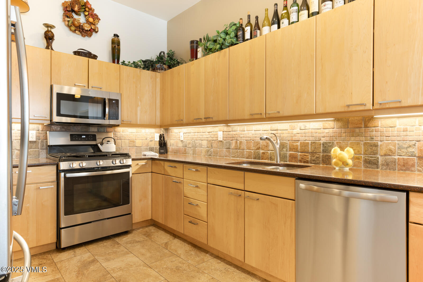 1230 Lions Ridge Loop, Unit 2D Vail, CO 81657 - Photo 17 of 42 a kitchen with stainless steel appliances a sink a stove and a microwave
