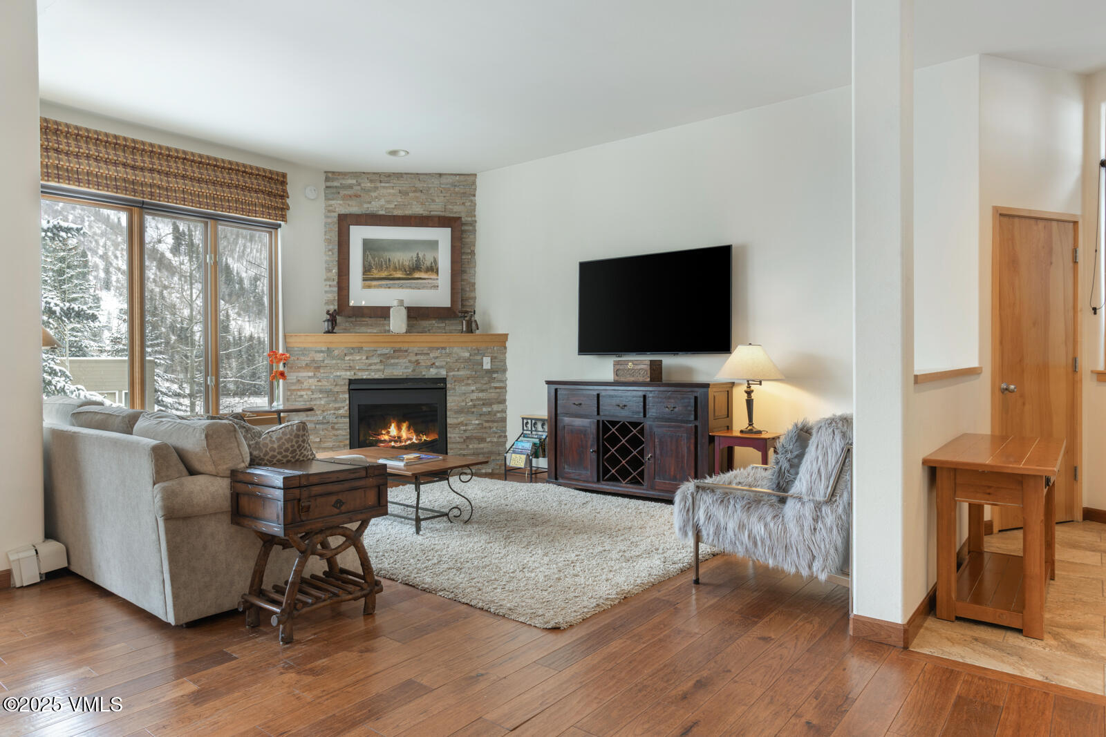 1230 Lions Ridge Loop, Unit 2D Vail, CO 81657 - Photo 19 of 42 a living room with furniture flat screen tv and a fireplace
