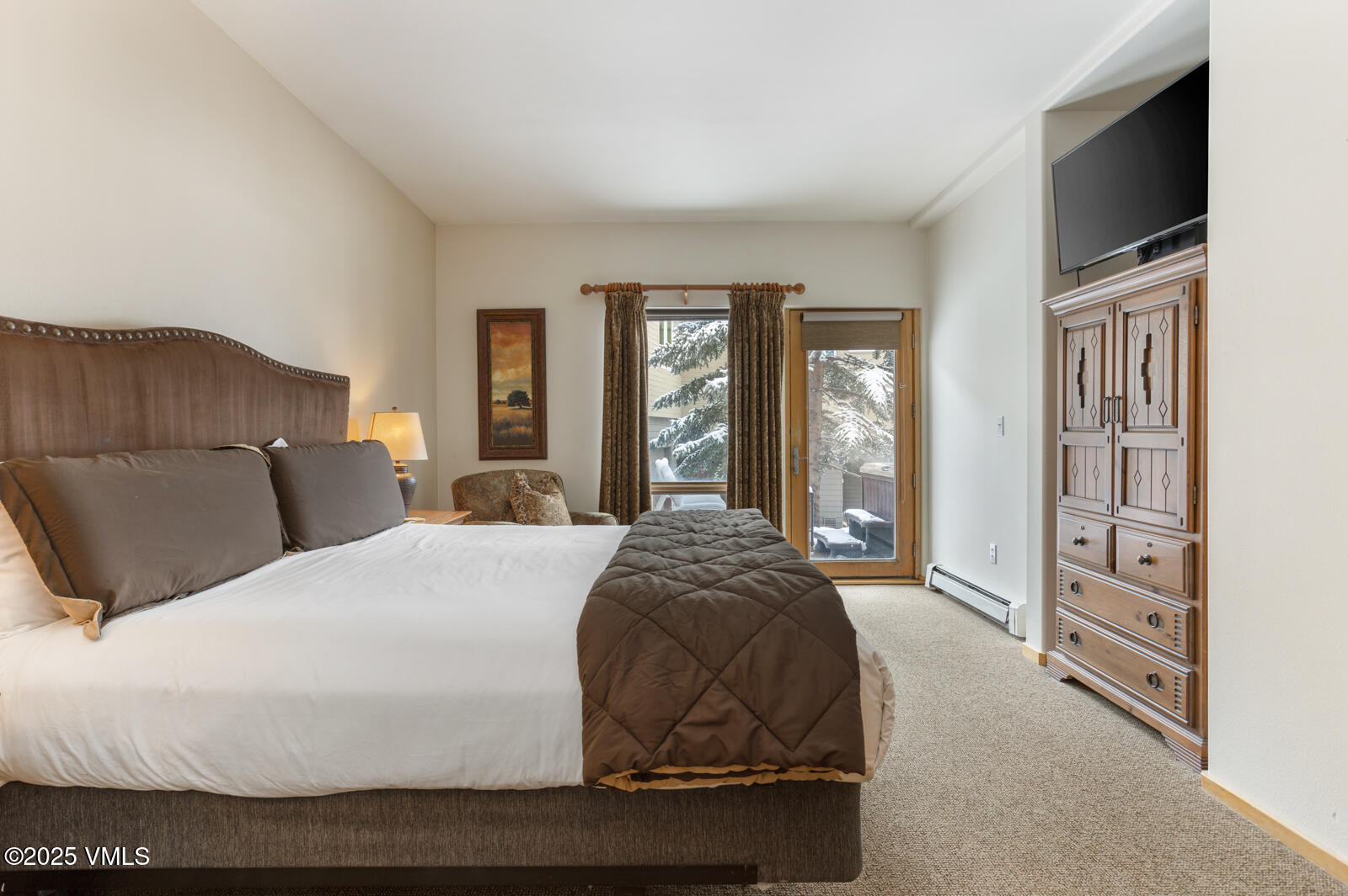 1230 Lions Ridge Loop, Unit 2D Vail, CO 81657 - Photo 23 of 42 a bedroom with a large bed and flat tv screen