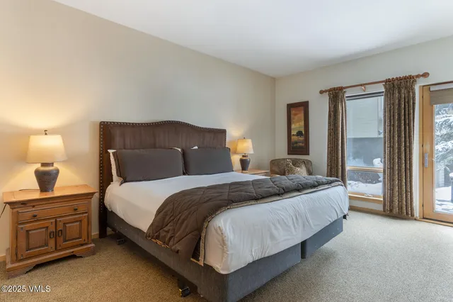 a bedroom with a bed and a large window