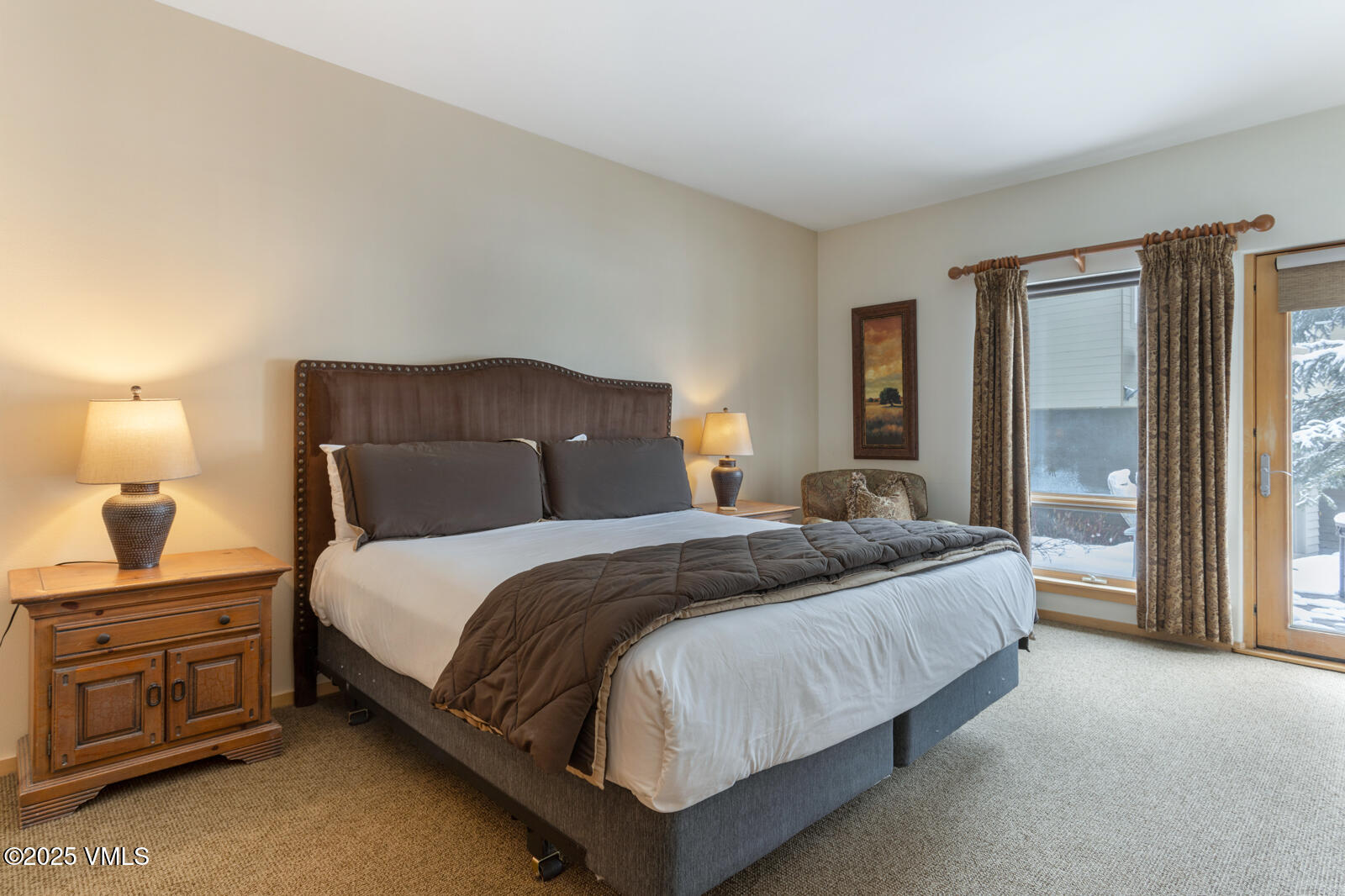 1230 Lions Ridge Loop, Unit 2D Vail, CO 81657 - Photo 24 of 42 a bedroom with a bed and a lamp with window