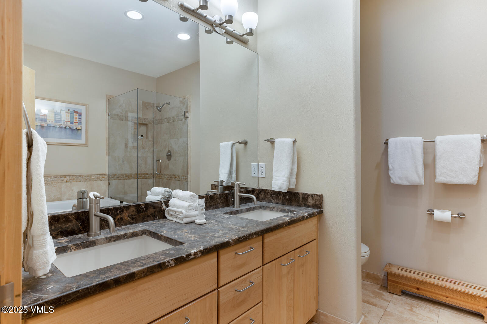 1230 Lions Ridge Loop, Unit 2D Vail, CO 81657 - Photo 25 of 42 a bathroom with a granite countertop sink and a mirror