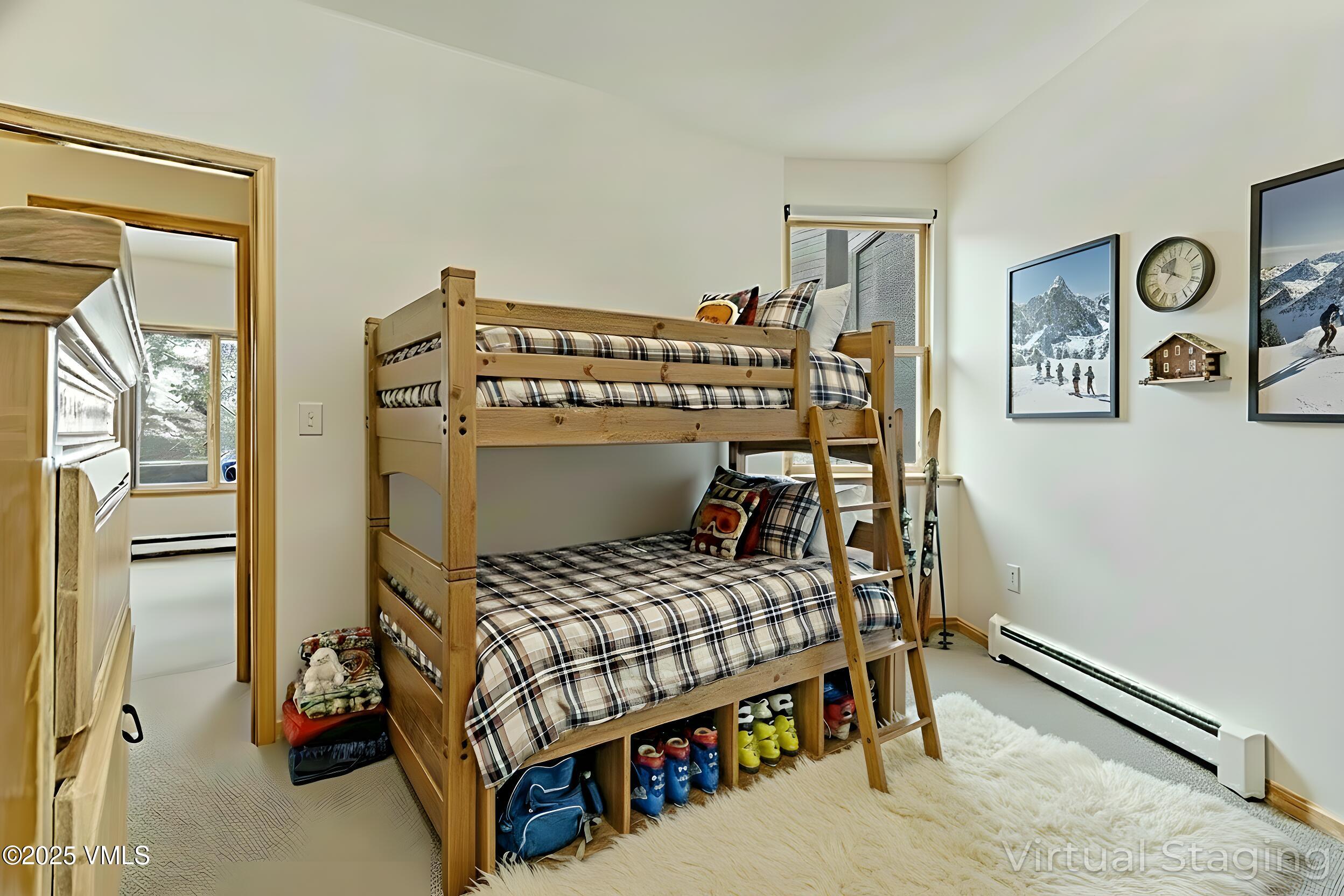 1230 Lions Ridge Loop, Unit 2D Vail, CO 81657 - Photo 30 of 42 a bedroom with a bed and wooden floor