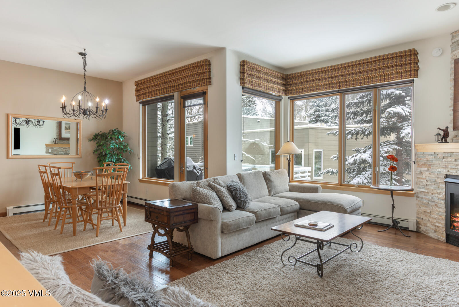 1230 Lions Ridge Loop, Unit 2D Vail, CO 81657 - Photo 3 of 42 a living room with furniture and a chandelier