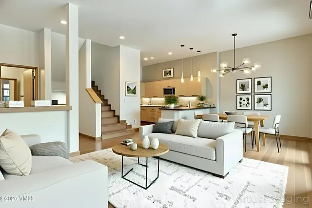 a living room with furniture and a chandelier