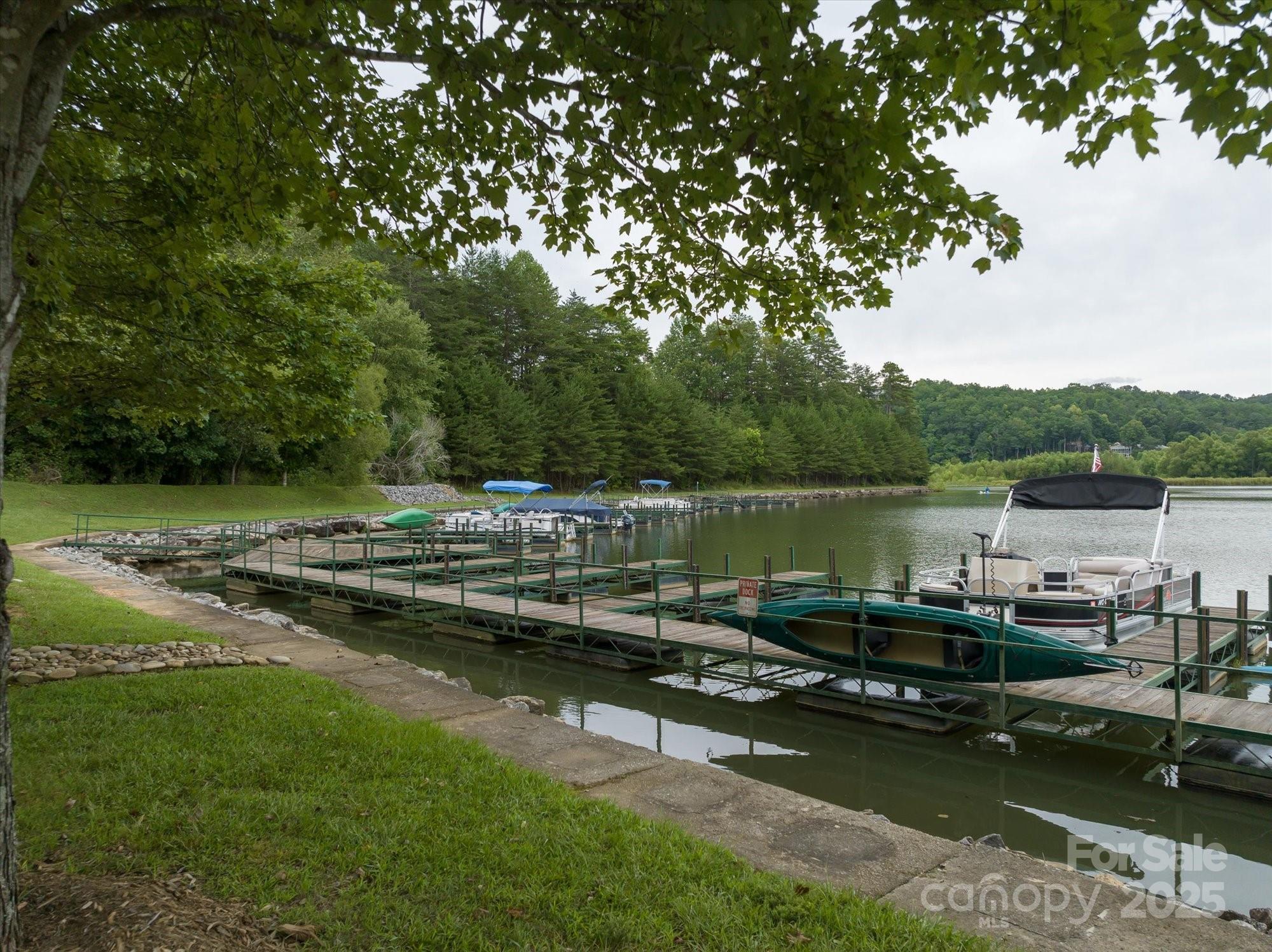 0 Twin Maple Way, Unit 5 Mill Spring, NC 28756 - Photo 14 of 16 a view of a lake with trees by side of it
