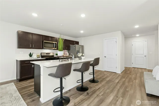 a kitchen with a sink cabinets and wooden floor