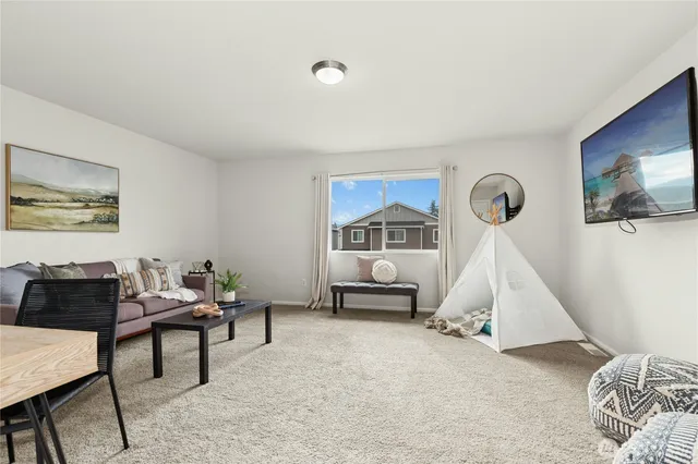 a living room with furniture and a painting on the wall