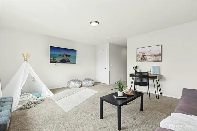 a living room with furniture and a potted plant