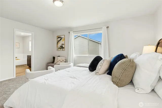 a bedroom with a bed and a painting